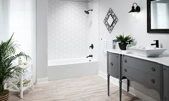 White hexagonal tile shower with dark vanity