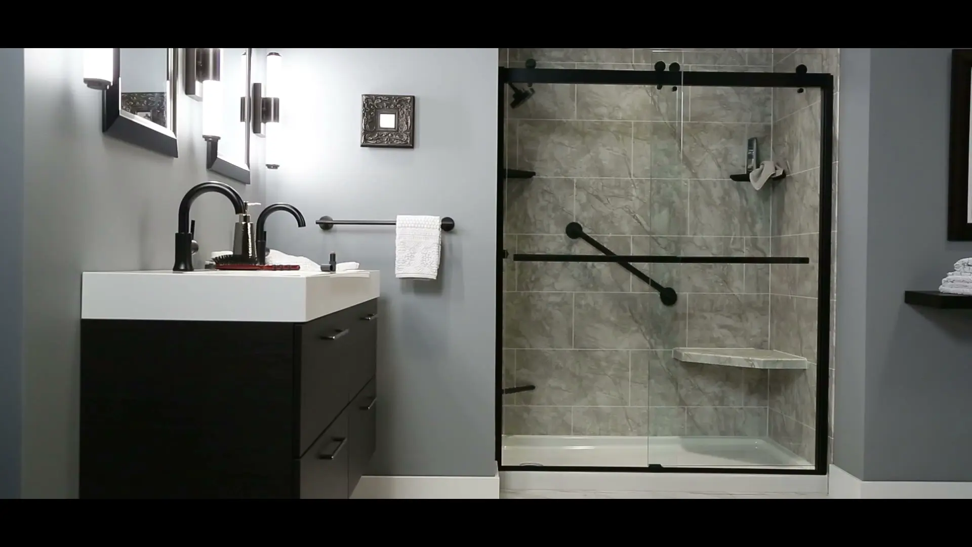 Black vanity with gray tile shower