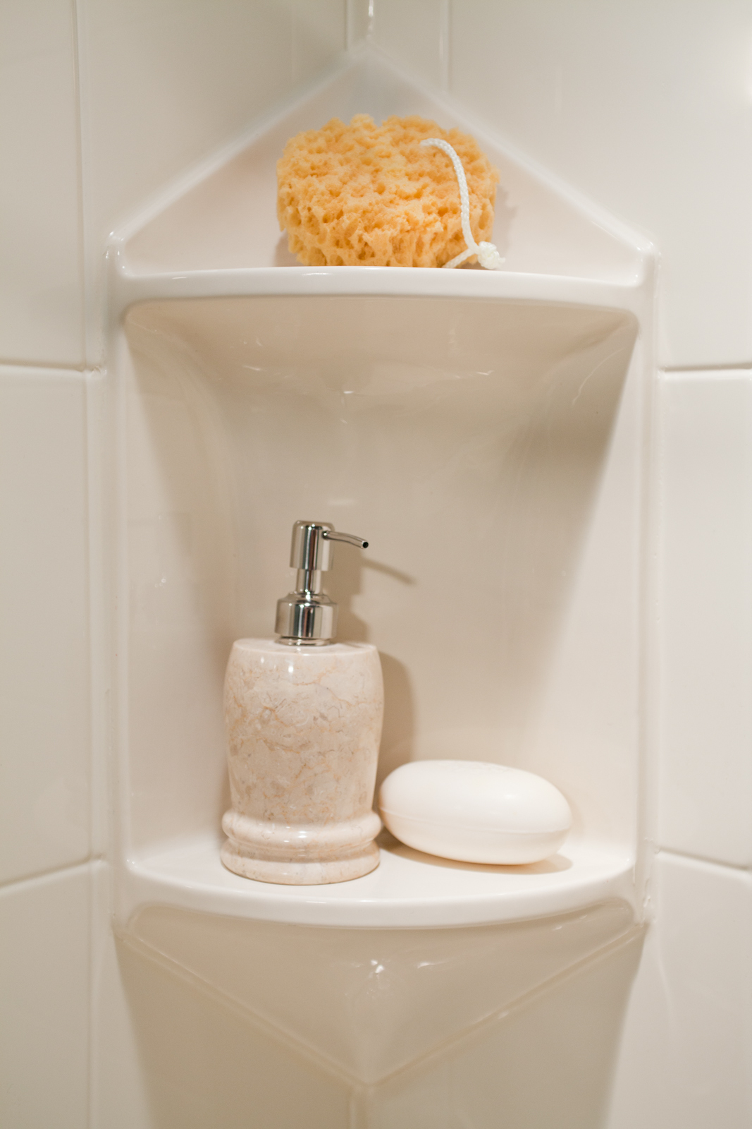 Two-shelf corner caddy in almond tile wall