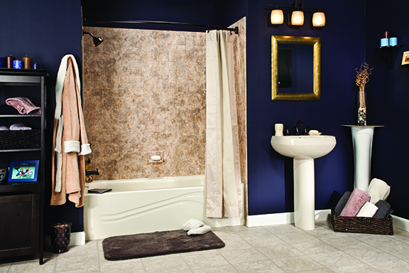 Biscuit tub with brecchia tile walls and oil-rubbed bronze in navy blue bathroom