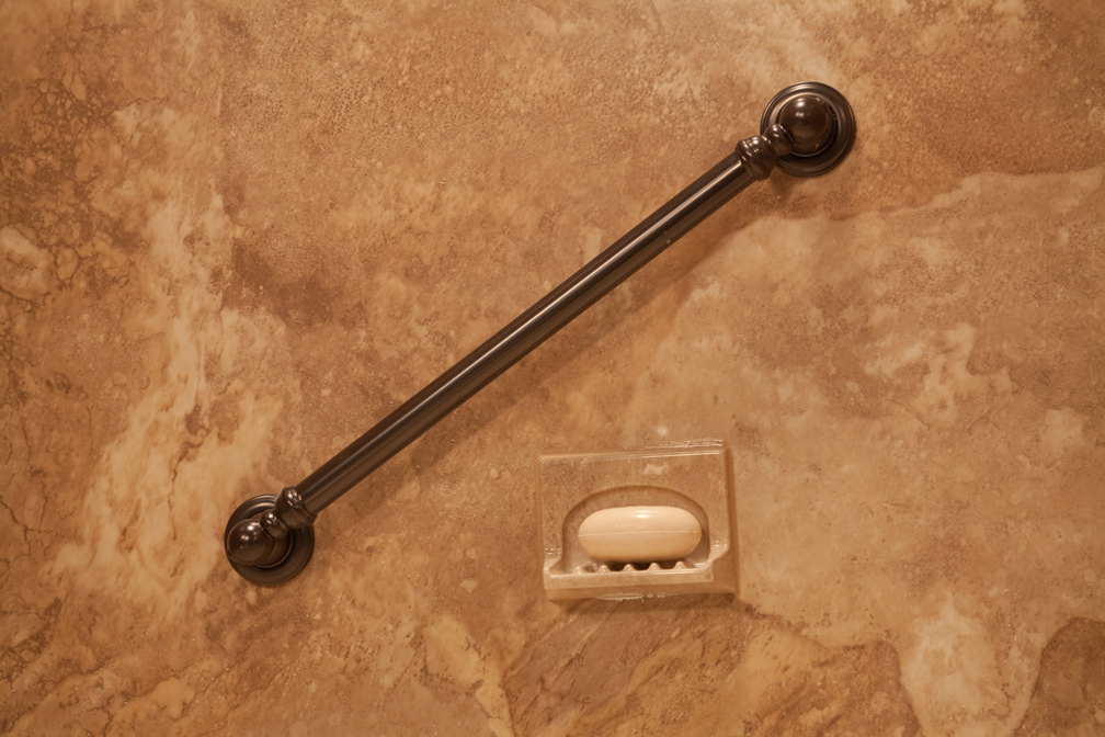 Oil-rubbed bronze grab bar on Venetian granite walls