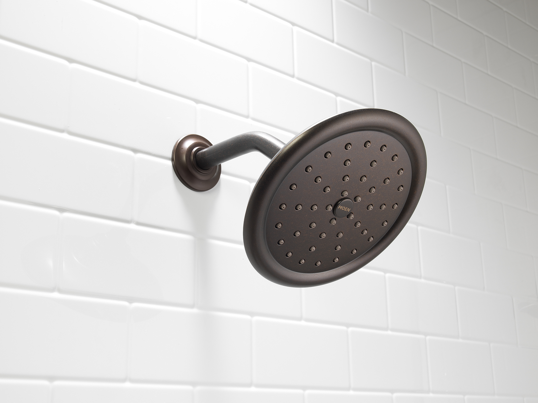 Oil-rubbed bronze rain shower head on white subway tile