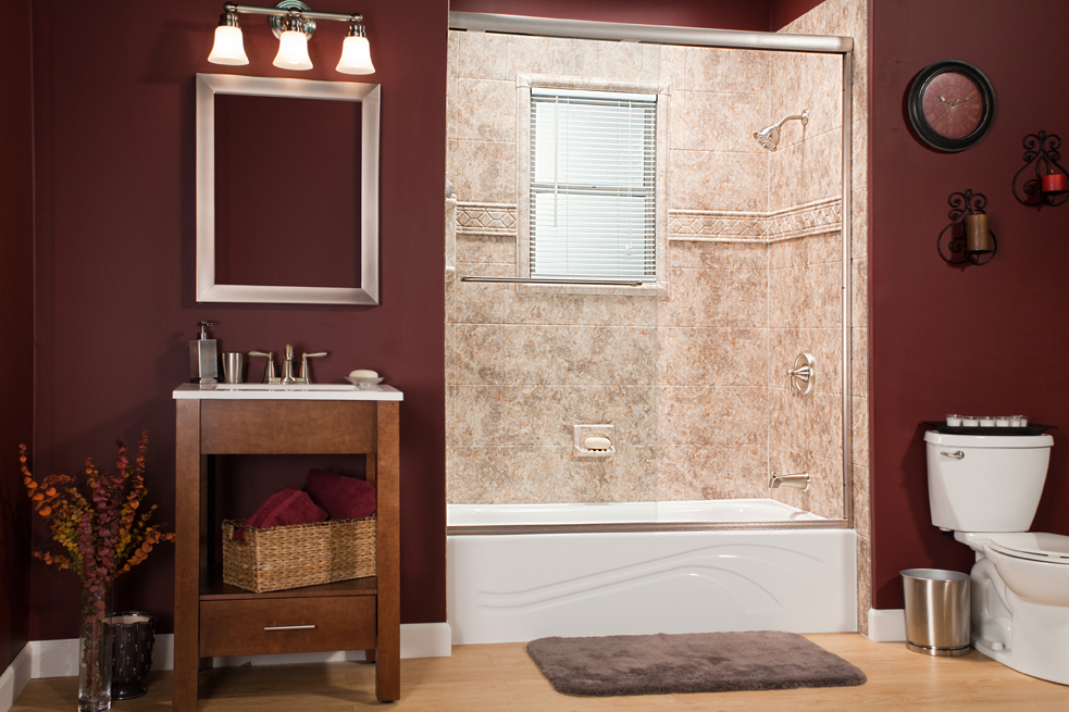 River rock wall surround with wave tub and listello trim in burgundy bathroom