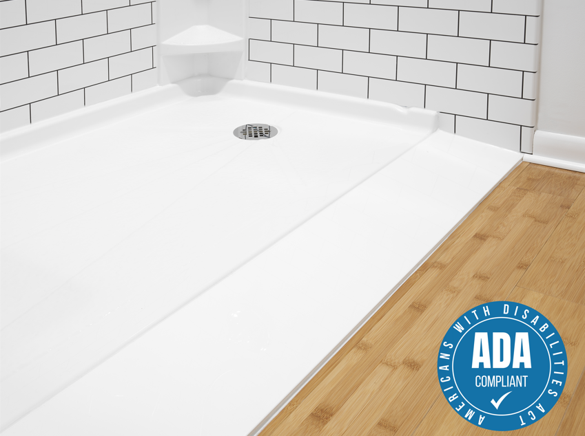 Ultra low shower base with ADA compliant badge showing flush-to-floor profile on hardwood bathroom floor