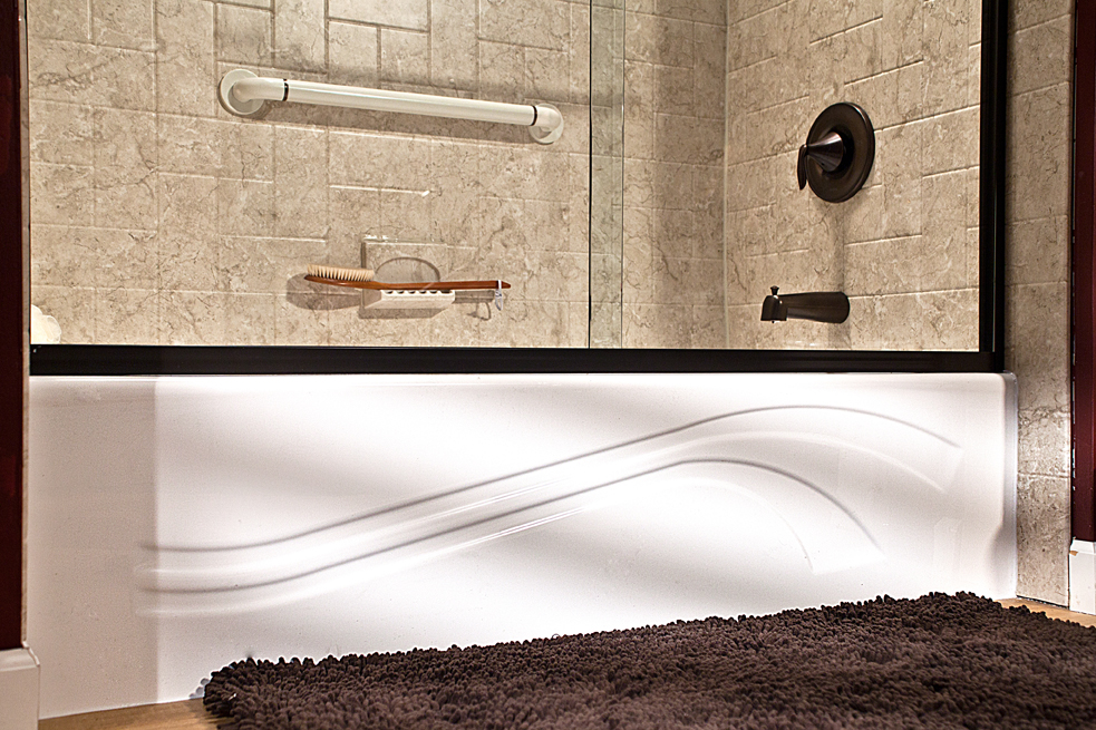 Wave tub close-up with brecchia windmill walls and oil-rubbed bronze fixtures
