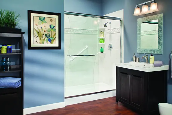 White shower base with silver marble walls, sliding glass doors, and blue room