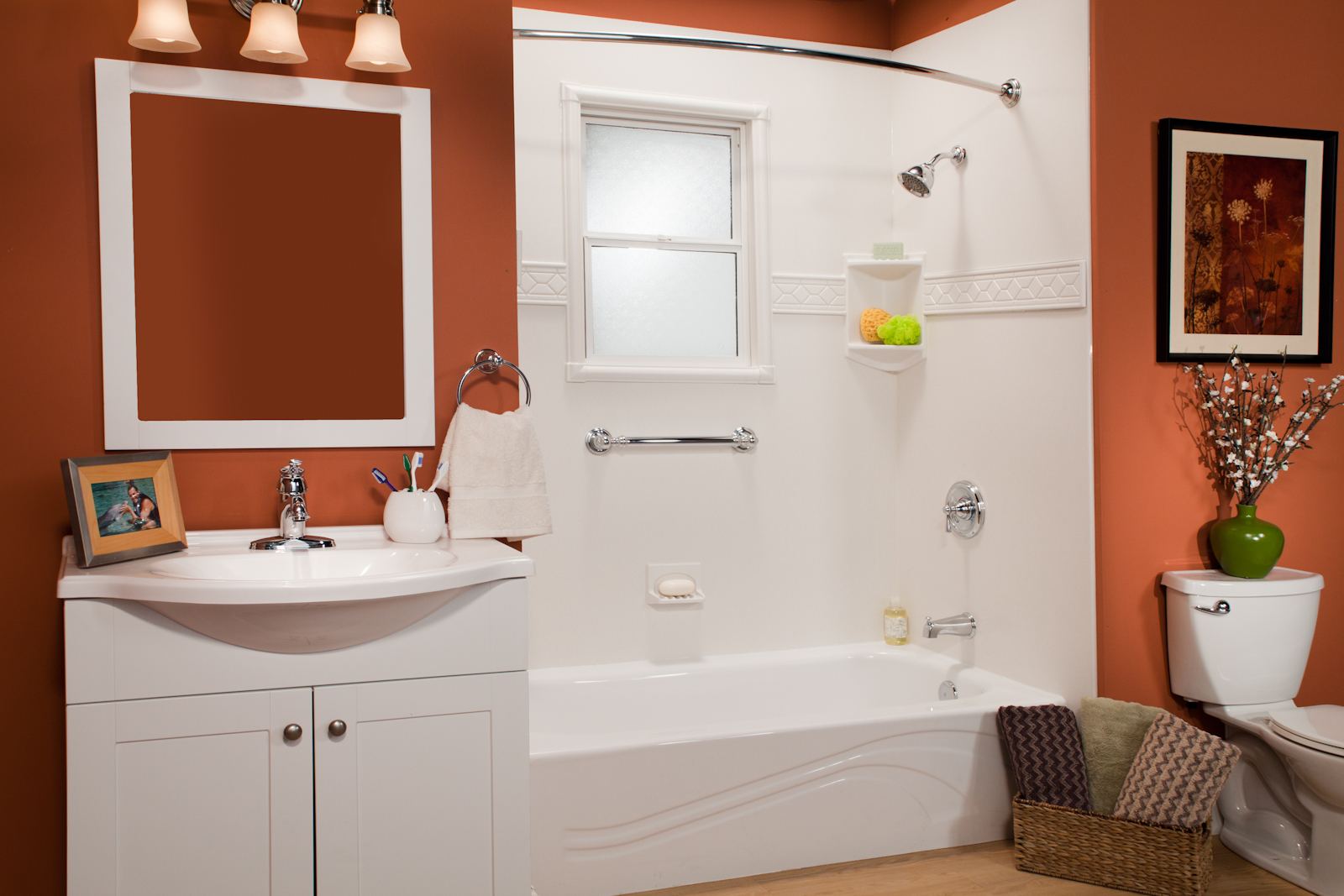 White wave tub with window kit, grab bars, and curved rod in terracotta bathroom